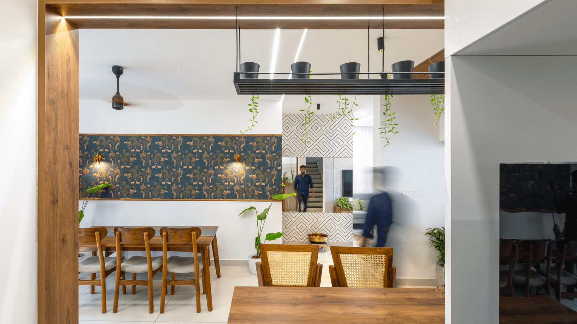 A kitchen and dining area featuring a blue wall, showcasing modern decor and a cozy atmosphere.